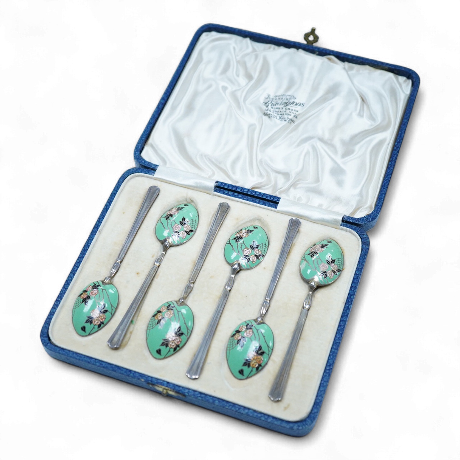 A cased set of six George V Art Deco silver and enamel coffee spoons, By Turner & Simpson, Birmingham, 1933, 98mm, the bowl backs decorated with a rose bush with spider's web.